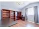 Home office featuring hardwood floors, large bookcase and plenty of room to work at 3921 W Jasper Dr, Chandler, AZ 85226