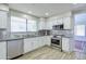 Well-lit kitchen with stainless steel appliances and white cabinetry at 3921 W Jasper Dr, Chandler, AZ 85226