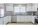 Bright kitchen with stainless steel appliances and white cabinets at 3921 W Jasper Dr, Chandler, AZ 85226