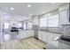 Modern kitchen with white cabinets, stainless steel appliances, and an open layout to living room at 3921 W Jasper Dr, Chandler, AZ 85226