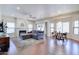 Open-concept living room with hardwood floors, a fireplace, and view into dining area at 3921 W Jasper Dr, Chandler, AZ 85226