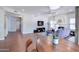 Open-concept living room with a fireplace, flat-screen TV, and wood flooring at 3921 W Jasper Dr, Chandler, AZ 85226