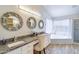 Elegant primary bathroom with dual sinks, granite countertops, decorative mirrors, and a separate tub at 3921 W Jasper Dr, Chandler, AZ 85226