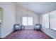 Cozy sitting area with a chandelier, hardwood flooring, natural light, and comfortable seating at 3921 W Jasper Dr, Chandler, AZ 85226