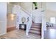 Staircase with wood treads and white risers leading to the second floor with view into living spaces at 3921 W Jasper Dr, Chandler, AZ 85226