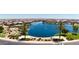 Breathtaking aerial view of a community lake surrounded by beautiful homes and lush landscaping at 39985 W Sparks Ln, Maricopa, AZ 85138