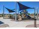 Community playground with multiple slides and shade structures, a safe recreational space for families at 39985 W Sparks Ln, Maricopa, AZ 85138