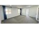 Bright bedroom featuring two windows with blue curtains and neutral carpet at 4125 W Villa Rita Dr, Glendale, AZ 85308