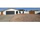 Charming single story home with a gray garage door, desert landscaping, and private fencing at 4125 W Villa Rita Dr, Glendale, AZ 85308