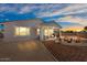 Cozy backyard with a covered patio, stylish outdoor seating, and desert landscaping at 435 E Shellie Ct, Casa Grande, AZ 85122