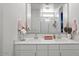 Bright bathroom with double sinks, quartz countertops, and a large framed mirror at 435 E Shellie Ct, Casa Grande, AZ 85122