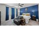 Inviting bedroom featuring a blue accent wall, ample natural light and a comfortable reading chair at 435 E Shellie Ct, Casa Grande, AZ 85122