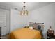 Comfortable bedroom with modern light fixture, patterned bedding, and neutral walls at 435 E Shellie Ct, Casa Grande, AZ 85122