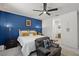 Comfortable bedroom with a blue accent wall, stylish decor, and a cozy reading chair at 435 E Shellie Ct, Casa Grande, AZ 85122
