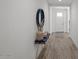 Hallway view featuring light gray wood-look flooring and a modern console table with decorative accents at 435 E Shellie Ct, Casa Grande, AZ 85122