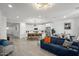 Open-concept kitchen and living room featuring modern appliances, a large island, and stylish decor at 435 E Shellie Ct, Casa Grande, AZ 85122