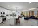 Open-concept kitchen and living room featuring modern appliances, a large island, and stylish decor at 435 E Shellie Ct, Casa Grande, AZ 85122