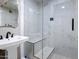 Modern bathroom featuring a glass enclosed shower with marble tile and a pedestal sink at 4401 N 24Th Pl, Phoenix, AZ 85016