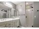 This updated bathroom features a double sink vanity and walk-in shower with neutral tones at 4401 N 24Th Pl, Phoenix, AZ 85016