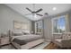 This staged bedroom boasts hardwood floors, light gray walls, plantation shutters, and a ceiling fan at 4401 N 24Th Pl, Phoenix, AZ 85016