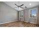 This bedroom has hardwood floors, light gray walls, plantation shutters, and a ceiling fan at 4401 N 24Th Pl, Phoenix, AZ 85016
