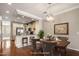 Staged dining area with wood table, elegant chandelier, and view into the beautifully appointed kitchen at 4401 N 24Th Pl, Phoenix, AZ 85016