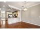Open-concept dining area showcases hardwood floors and view into the kitchen area at 4401 N 24Th Pl, Phoenix, AZ 85016