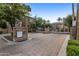 Welcoming gated entrance to a meticulously maintained community with lush landscaping and charming architecture at 4401 N 24Th Pl, Phoenix, AZ 85016