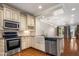 Well-equipped kitchen with stainless steel appliances, farmhouse sink, and wood flooring at 4401 N 24Th Pl, Phoenix, AZ 85016