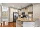 Kitchen featuring stainless steel appliances, granite counters, tile backsplash, and wood floors at 4401 N 24Th Pl, Phoenix, AZ 85016