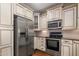 Spacious kitchen featuring stainless steel appliances, wood floors, and light-colored cabinetry at 4401 N 24Th Pl, Phoenix, AZ 85016