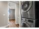 Upstairs laundry area with stacked washer and dryer, with bedroom visible through the doorway at 4401 N 24Th Pl, Phoenix, AZ 85016