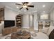 Staged living room with ceiling fan, built-in bookshelf, and decorative coffee table at 4401 N 24Th Pl, Phoenix, AZ 85016