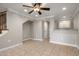 Open-concept living room features tile flooring, ceiling fan, and access to other areas at 4401 N 24Th Pl, Phoenix, AZ 85016