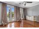 Living room boasts hardwood floors, ceiling fan, and French doors that access a pool at 4401 N 24Th Pl, Phoenix, AZ 85016