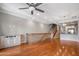 Open-concept living area showcasing hardwood floors, staircase, ceiling fan and adjacent kitchen area at 4401 N 24Th Pl, Phoenix, AZ 85016