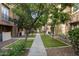 Charming walkway lined with trees and manicured lawns, creating a serene and picturesque setting at 4401 N 24Th Pl, Phoenix, AZ 85016