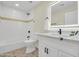 Modern bathroom featuring a vanity with a lighted mirror, a bathtub-shower, and sleek, dark fixtures at 4910 E Shaw Butte Dr, Scottsdale, AZ 85254