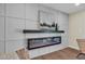 Modern fireplace with black shelf, gray and white paneled wall, and contemporary art at 4910 E Shaw Butte Dr, Scottsdale, AZ 85254