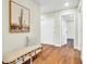 Inviting hallway with hardwood floors, a decorative bench, and a cactus wall art at 4910 E Shaw Butte Dr, Scottsdale, AZ 85254