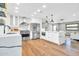 Modern kitchen with stainless appliances, custom white cabinetry, stone counter tops and wood flooring at 4910 E Shaw Butte Dr, Scottsdale, AZ 85254