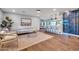 Open concept living space with stylish seating, view of the bar area, and hardwood floors at 4910 E Shaw Butte Dr, Scottsdale, AZ 85254