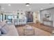 Spacious living area with open layout flowing into kitchen, featuring hardwood floors and stylish furnishings at 4910 E Shaw Butte Dr, Scottsdale, AZ 85254