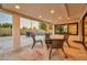 Comfortable outdoor lounge area on travertine patio, complete with wicker furniture and a fire pit at 4910 E Shaw Butte Dr, Scottsdale, AZ 85254