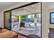 Inviting covered patio with travertine tile flooring, recessed lighting, and outdoor seating area at 4910 E Shaw Butte Dr, Scottsdale, AZ 85254