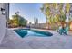Sparkling pool with travertine tile surround, complemented by lounge chairs and mature landscaping at 4910 E Shaw Butte Dr, Scottsdale, AZ 85254