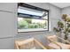 Interior shot of a window looking out onto a well-maintained garden and neighboring home at 4910 E Shaw Butte Dr, Scottsdale, AZ 85254