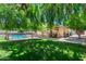 Lush backyard features a sparkling pool, covered patio, mature trees, and plenty of space for outdoor activities at 5132 E Grandview Rd, Scottsdale, AZ 85254