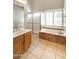 Bright bathroom featuring a large soaking tub, glass enclosed shower, and vanity with sink at 5132 E Grandview Rd, Scottsdale, AZ 85254