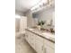 Bathroom with double vanity, decorative countertop, framed mirror, and shower-tub combo at 5132 E Grandview Rd, Scottsdale, AZ 85254
